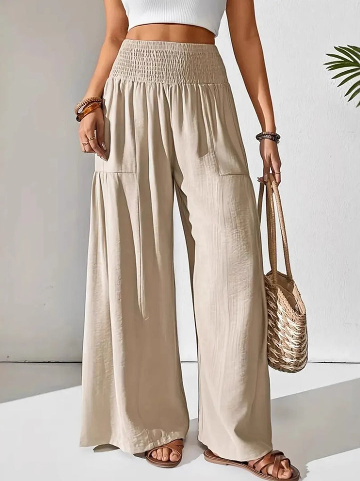 Women's effortless smocked waist wide leg pants, perfect for comfortable casual summer fashion.