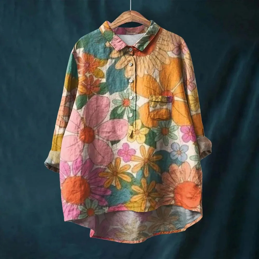 Spring/Summer women's long-sleeve blouse featuring a vibrant blooming floral print. Comfortable & chic.