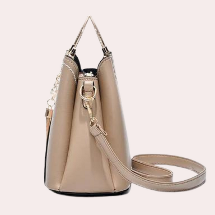 Black women's versatile geometric bag, durable fabric with multi-pocket interior and metallic accent.