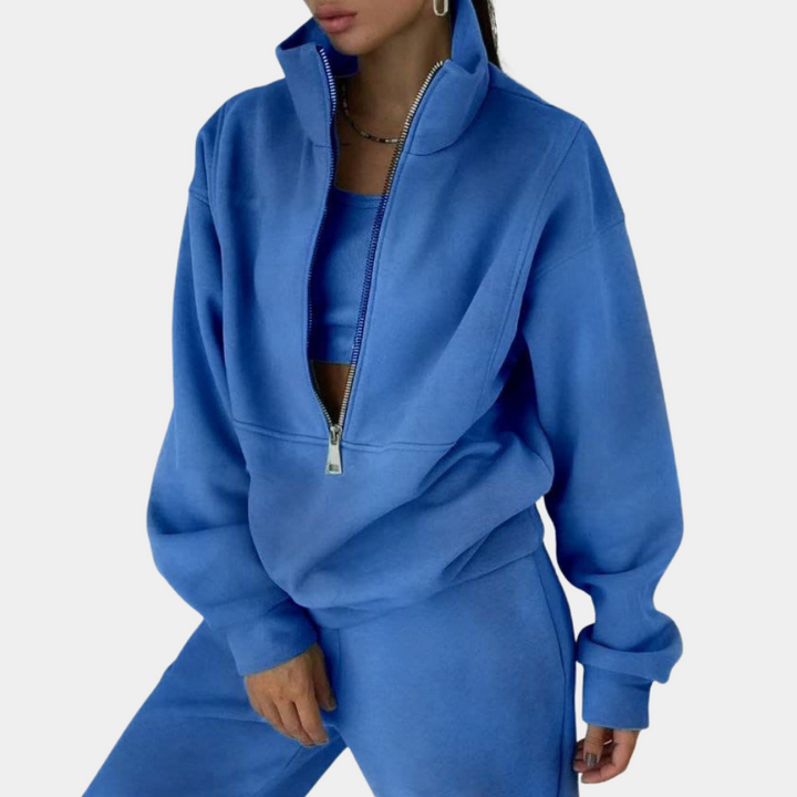 Woman jogging in a chic two-piece athletic tracksuit, ideal for activewear or a stylish casual outfit.