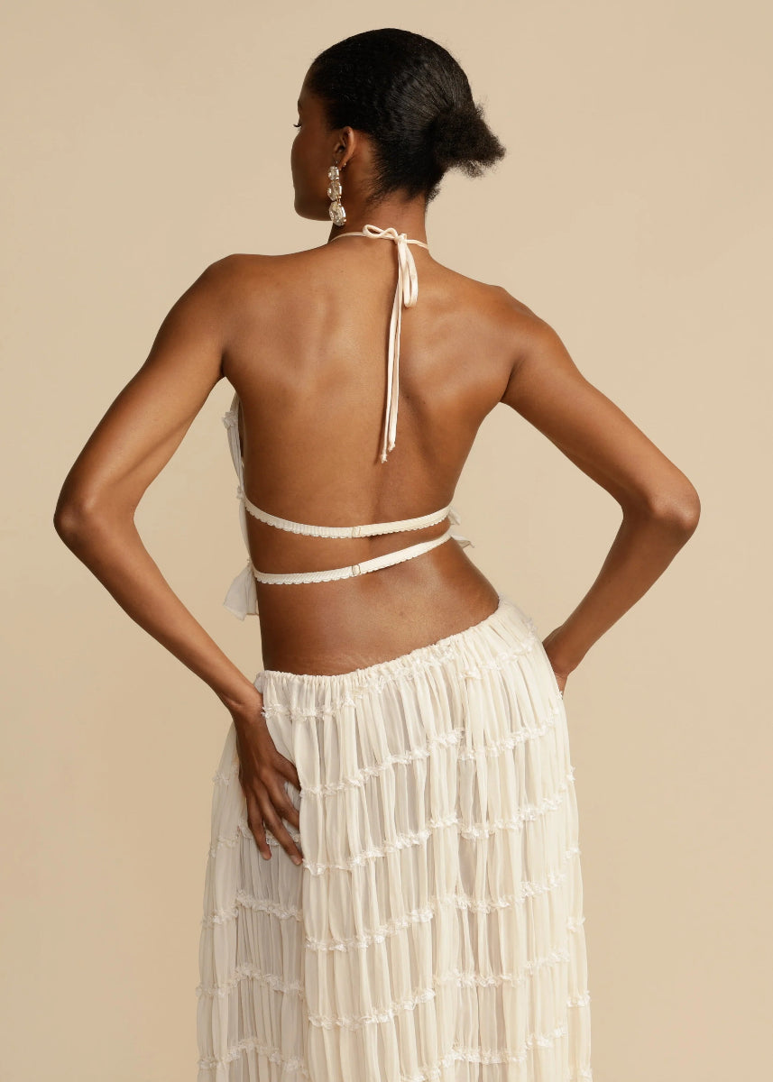 Flowy women's two-piece summer outfit with a comfortable halter top & lightweight maxi skirt, perfect for resort trips.