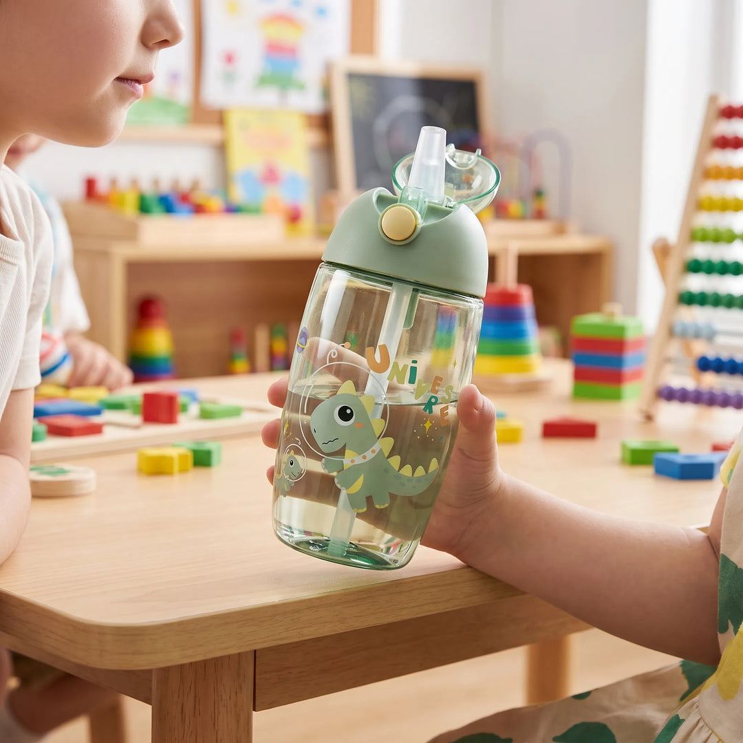 Children's cartoon dinosaur water bottle with integrated straw for school hydration.