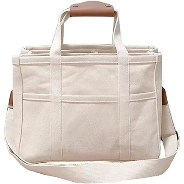 Women's spacious beige canvas tote bag with multiple pockets, perfect as an everyday shoulder or travel bag.