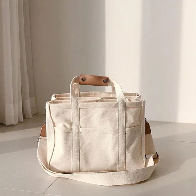 Large capacity women's multi-pocket canvas tote bag, ideal for daily essentials, travel, or work.