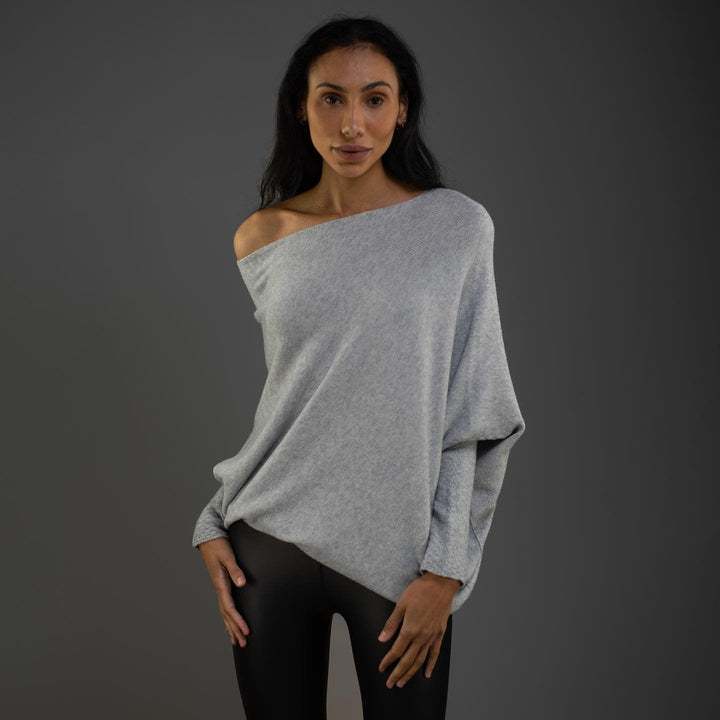 Cozy knit women's off-shoulder sweater with long sleeves. Soft fabric, versatile for everyday fashion.