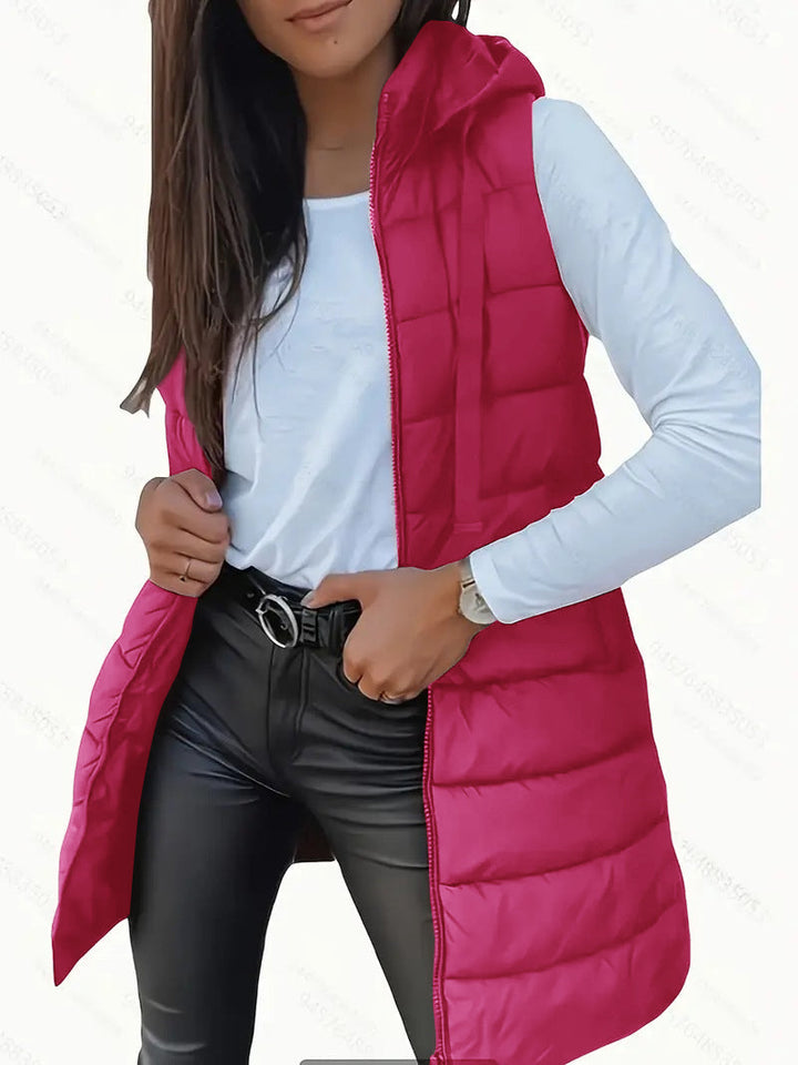 Women's black hooded long puffer vest, a lightweight sleeveless layering piece for cooler days.