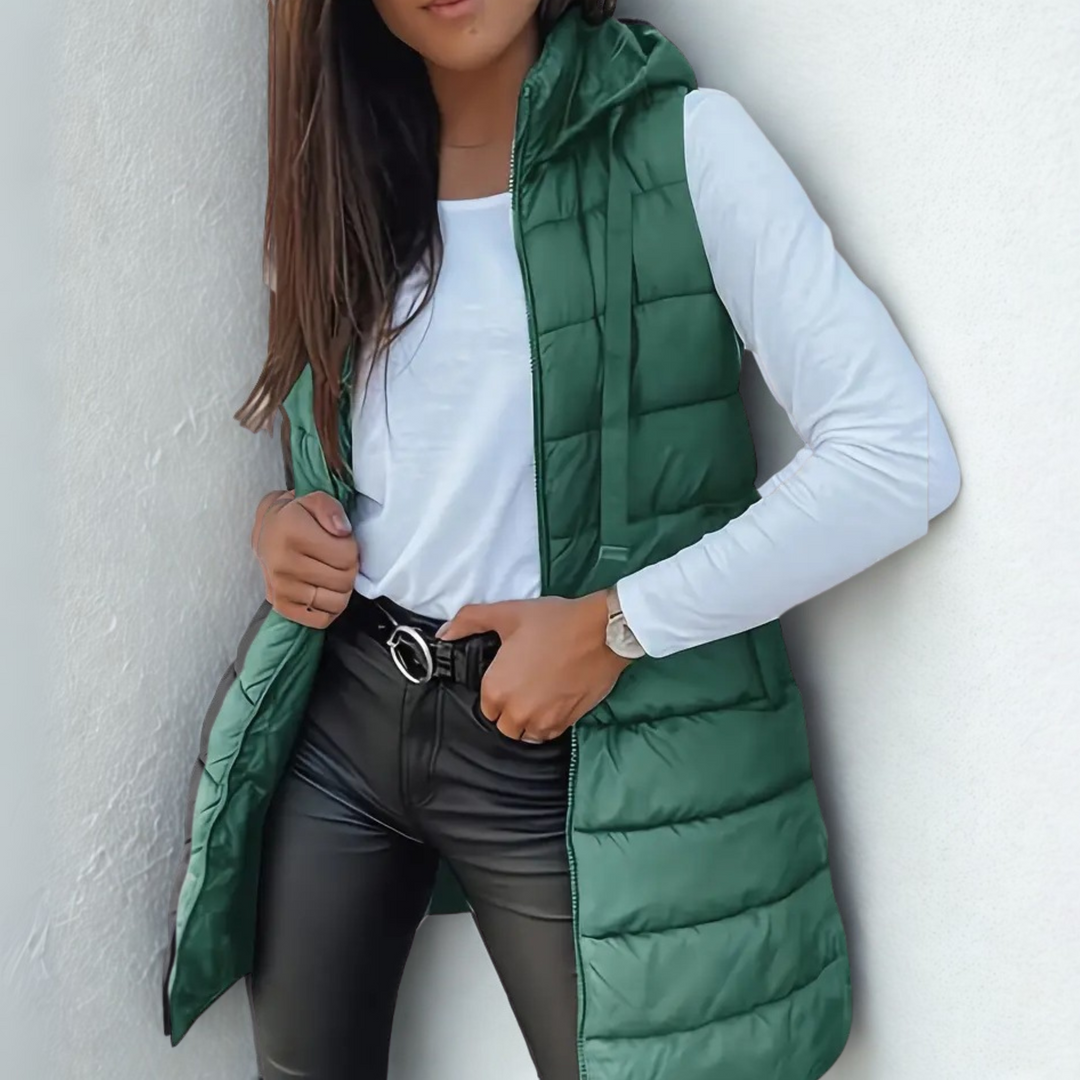 Chic women's sleeveless long puffer vest, hooded and lightweight, perfect for autumn layering.
