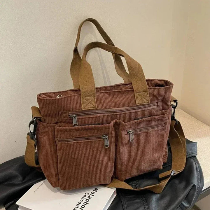 Organizer corduroy tote bag for women, with multiple pockets. Convertible to shoulder or crossbody, great for travel.