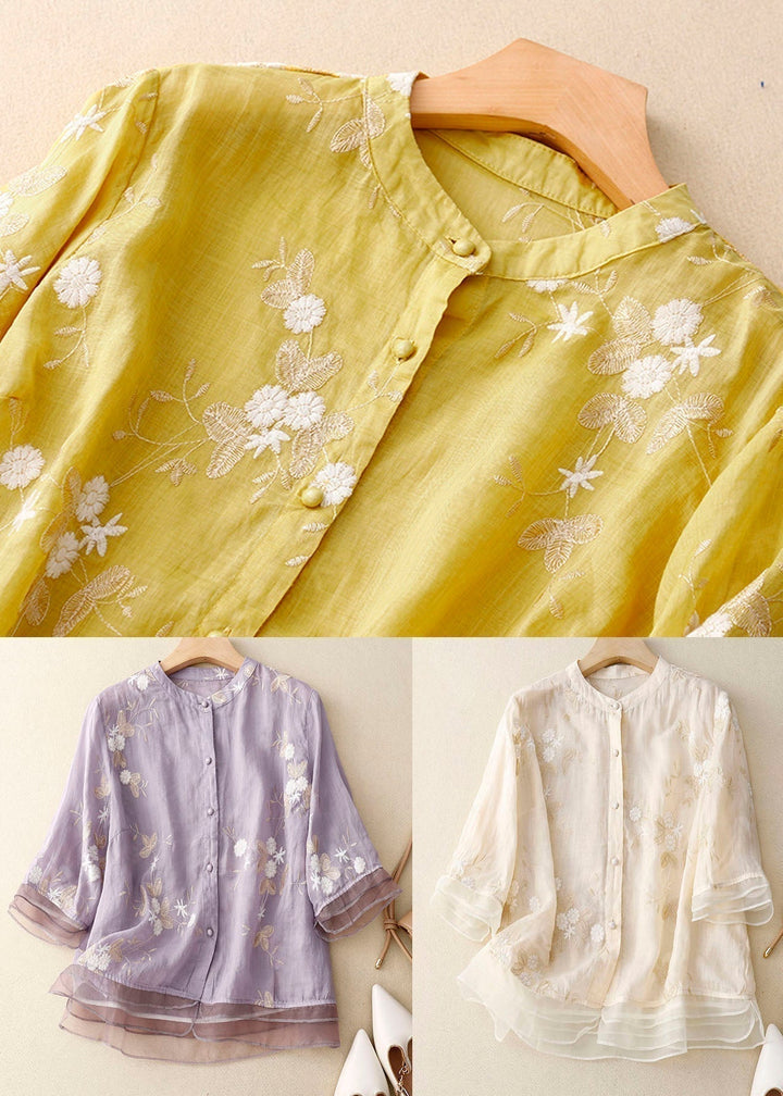 Elegant women's sheer layered blouse featuring intricate floral embroidery. A stylish and versatile long sleeve top.