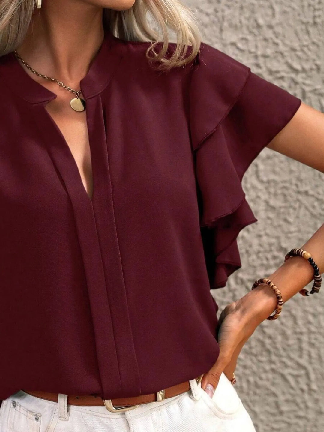 Delicate ruffled short sleeve women's blouse, a versatile lightweight top for elegant casual style.