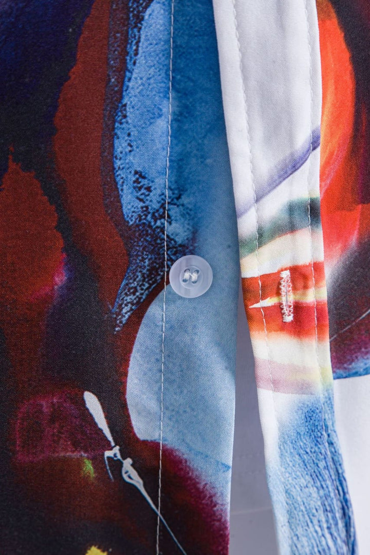 Relaxed fit men's tropical aloha shirt with a bright sunburst pattern, ideal for warm weather casual style.