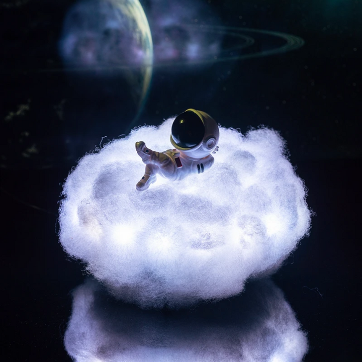 Color changing LED cloud night light with astronaut design, creating a magical atmosphere in kids' rooms.