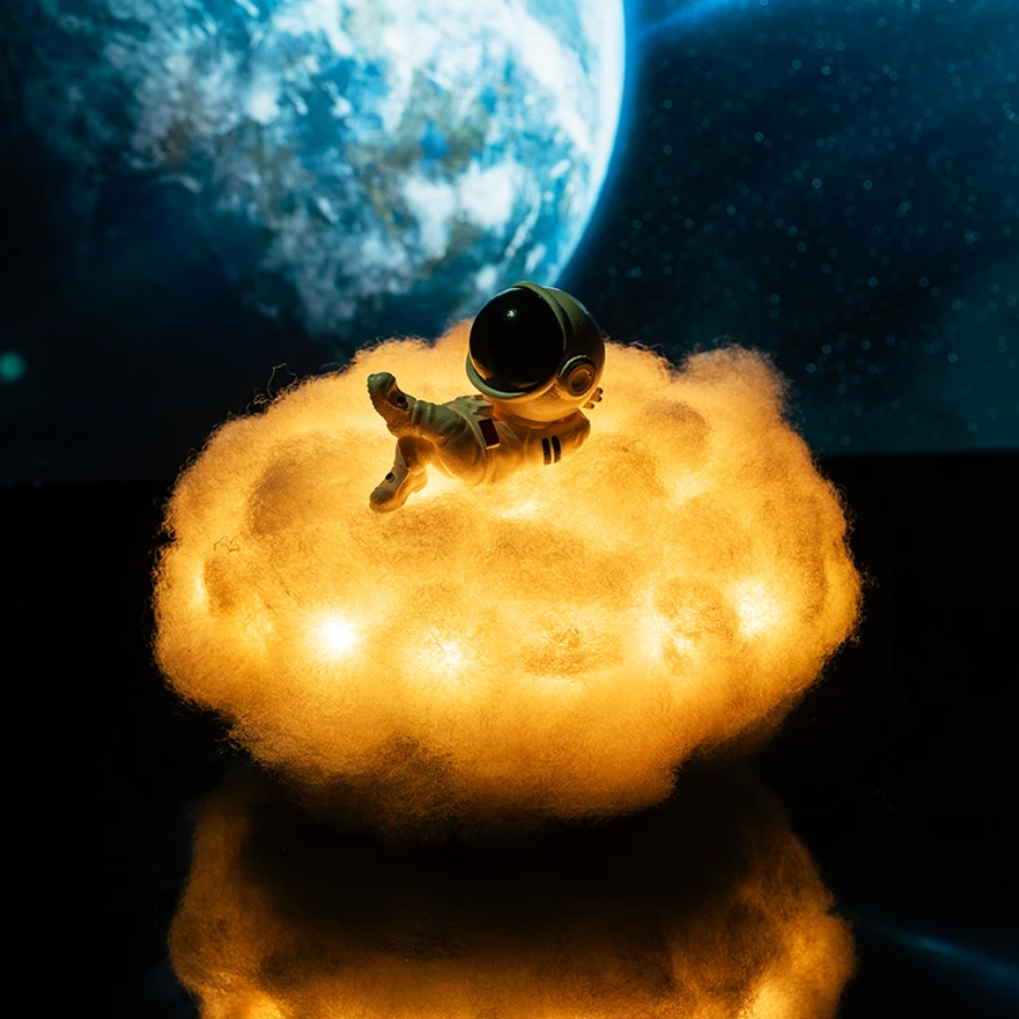 White cloud night light with a tiny astronaut, projecting soft stars. Ideal bedside lamp for toddlers & kids.