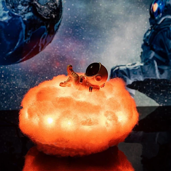 Kids' starry night projector lamp in a cloud shape with an astronaut. Soft LED glow for children's bedrooms.