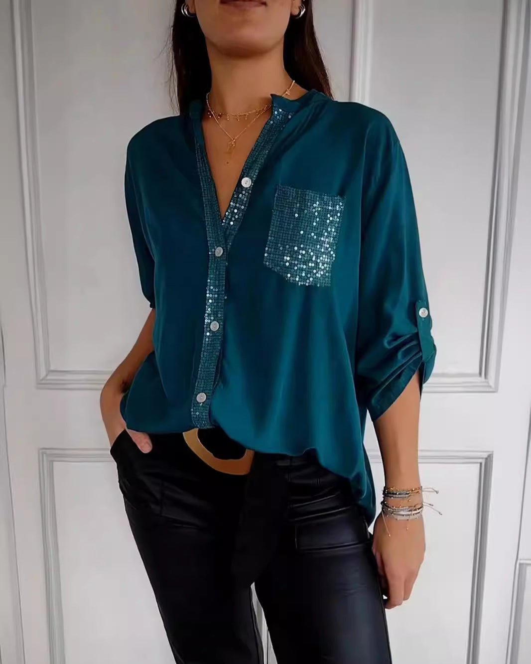Sophisticated women's sequin blouse. Elegant sparkle top with a relaxed fit for versatile chic style.