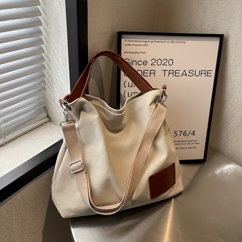 Stylish cream white large canvas tote bag for women with adjustable shoulder strap, casual everyday look.