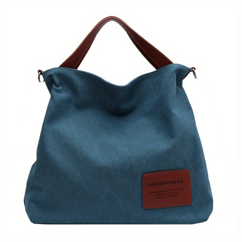 Chic women's large canvas shoulder tote bag, adjustable strap for comfort, ideal for work or casual outings.