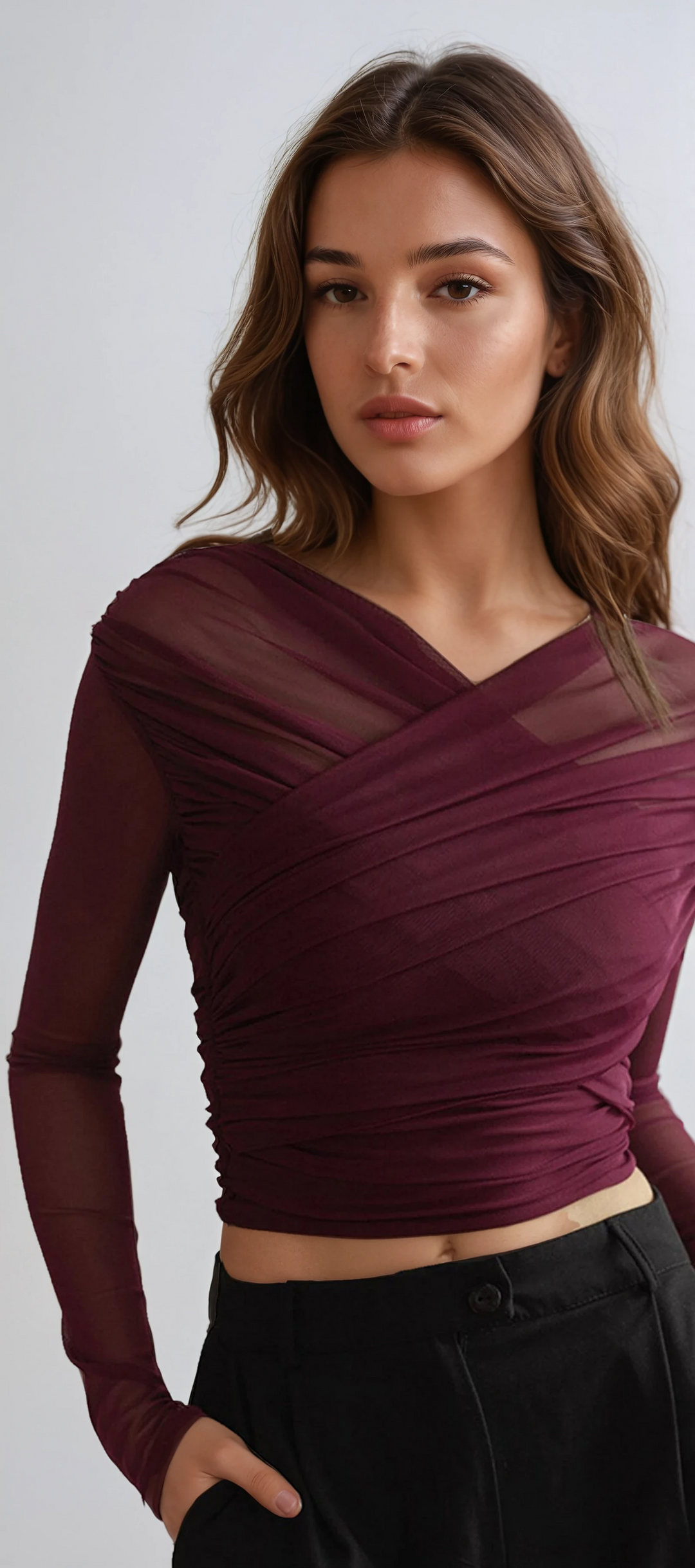 Women's sheer mesh long sleeve top with elegant ruching, perfect for evening wear.