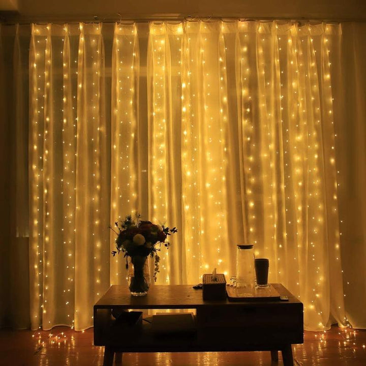 Fairy curtain string lights with warm white LEDs, creating a captivating backdrop for events.