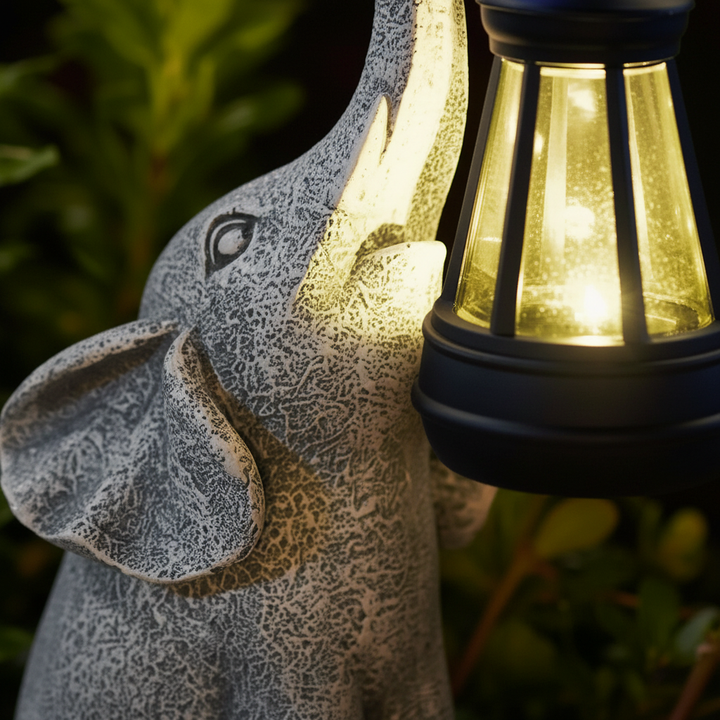 Glowphant solar elephant outdoor lamp, automatic garden light. Weatherproof resin patio decor for charming illumination.