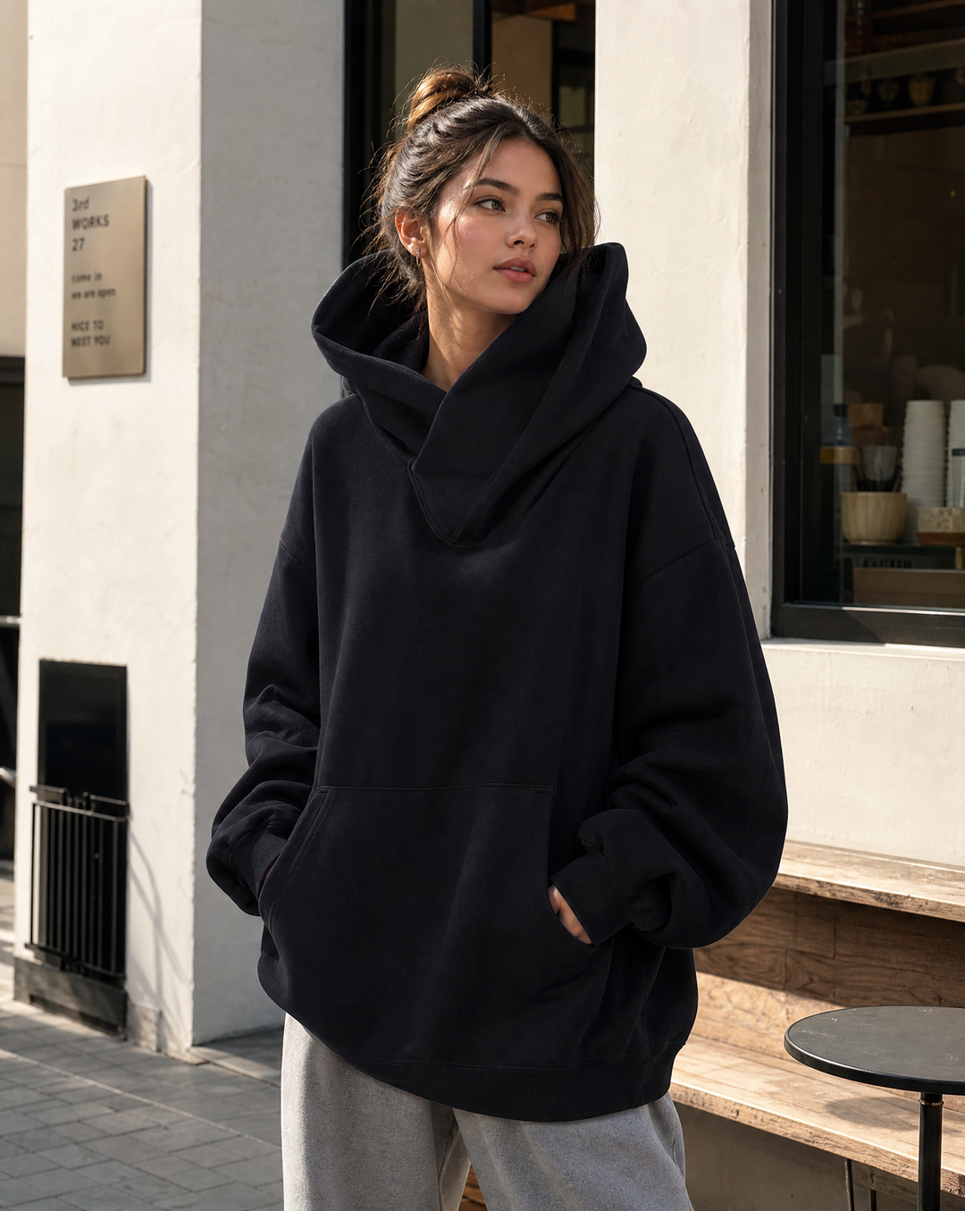 Close-up of soft fabric on a women's oversized turtleneck sweatshirt, highlighting its cozy & comfortable texture.