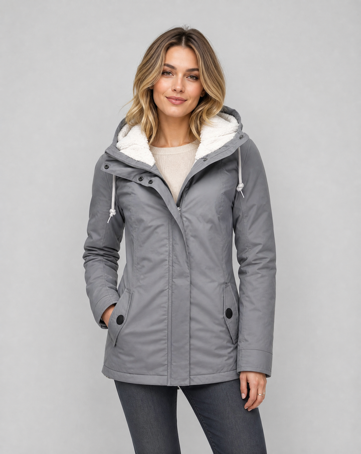 Women's waterproof rain jacket with hood, ideal for outdoor protection & stylish comfort.