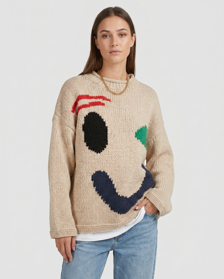 Cozy women's oversized smiley face sweater, a stylish and comfortable knit top for cooler weather.