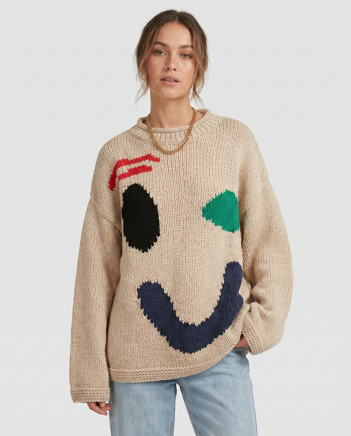 Trendy long sleeve women's oversized knit sweater featuring a cheerful smiley face for everyday outfits.