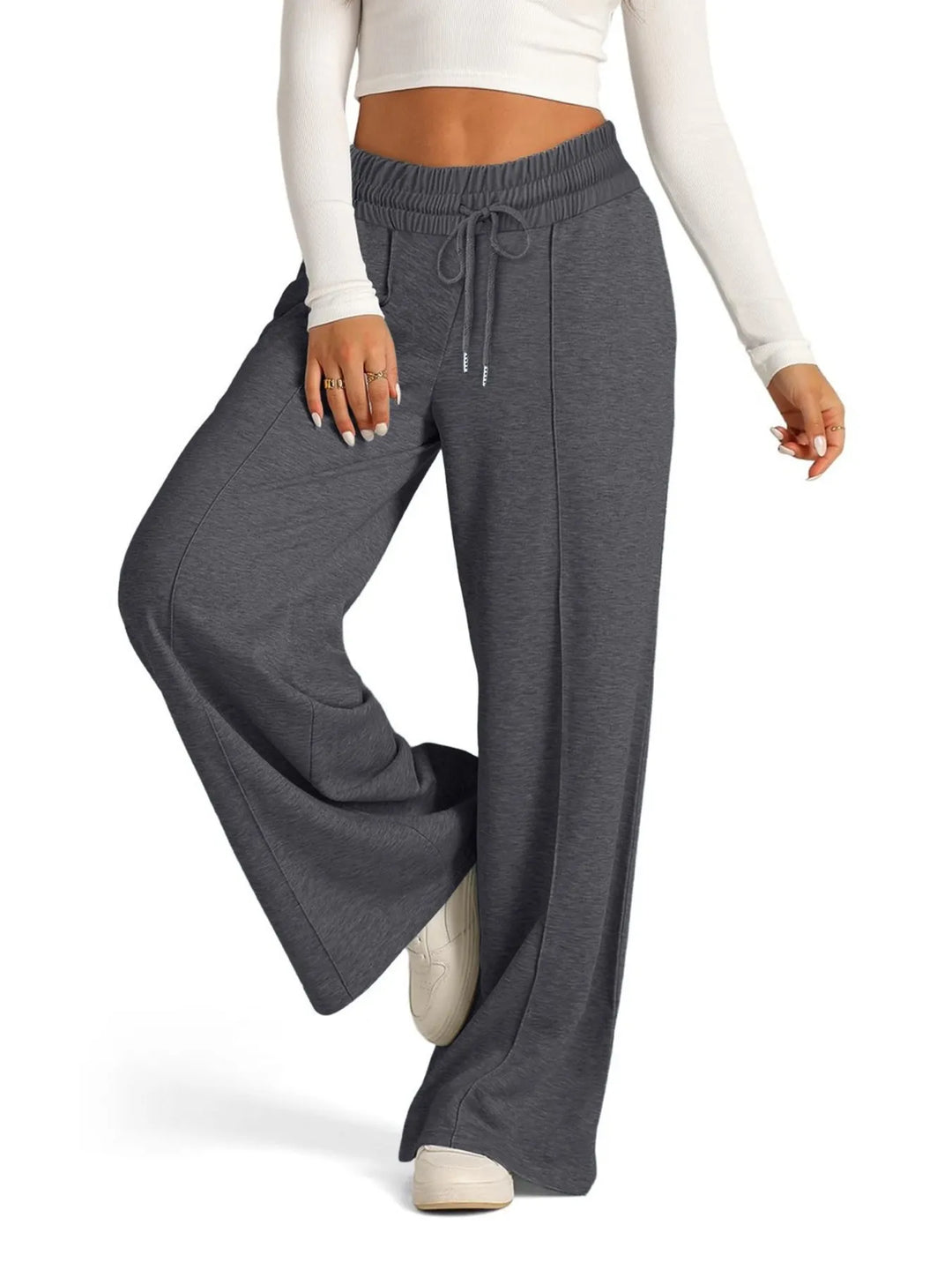Women's comfortable wide leg pants featuring a stretchy drawstring waist and pockets.
