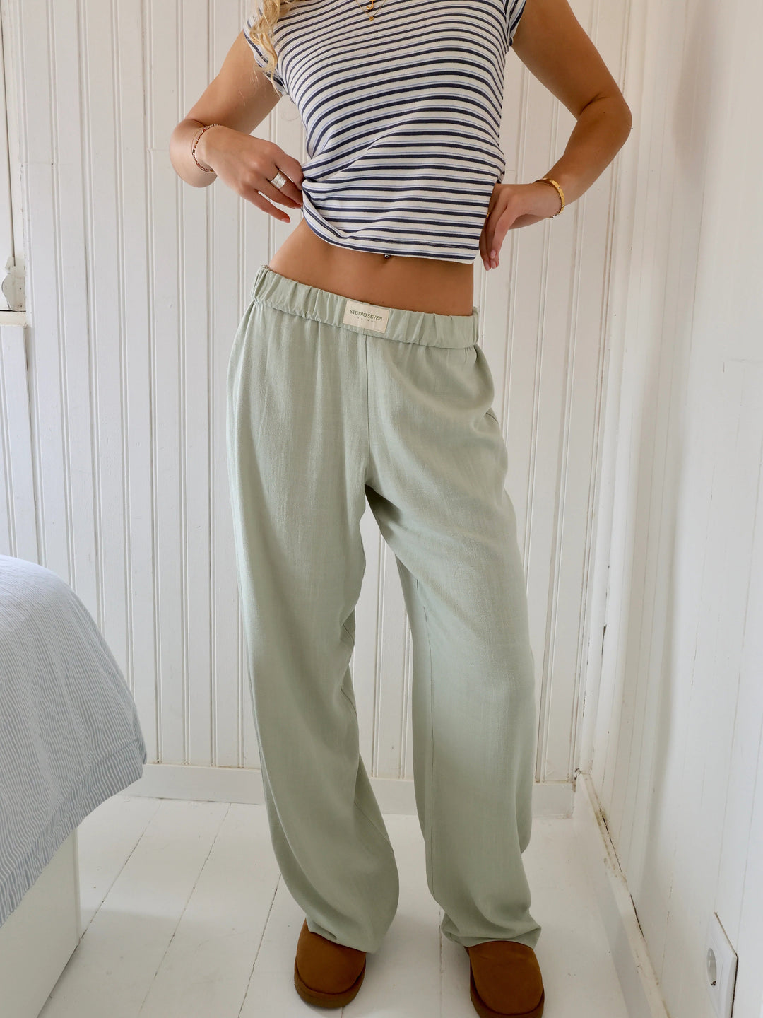 Soft, relaxed fit women's lounge pants featuring an elastic waist & pockets for comfortable, casual style.