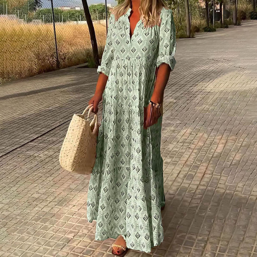Comfortable women's bohemian maxi dress. Features a flattering V-neck, long sleeves & flowy skirt. Ideal casual summer wear.