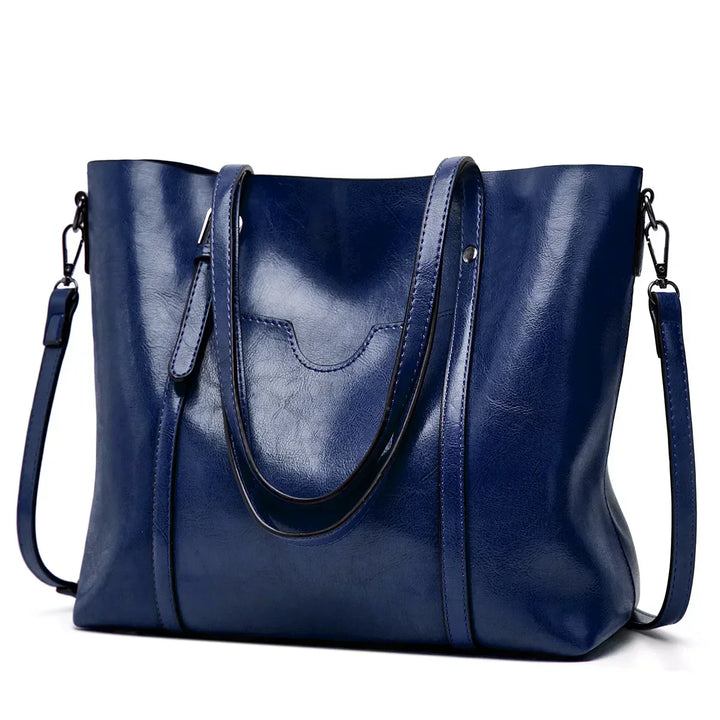 Close-up of premium genuine leather texture on an elegant women's luxury handbag, showcasing quality.