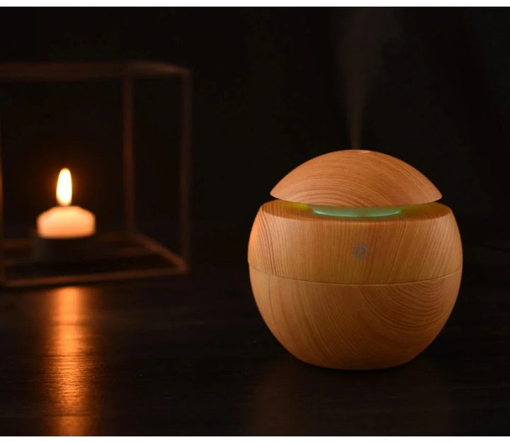 Mini wood grain diffuser with calming mood light, enhances relaxation & home ambiance.