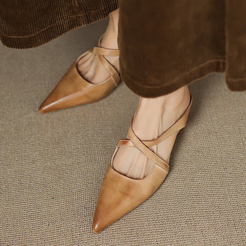Stylish women's pointed toe slip-on mules, featuring chic cross-straps and a low heel for versatile elegance.