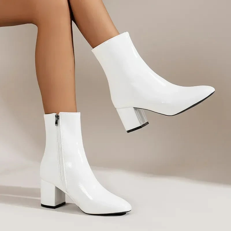 Women's elegant pointed toe ankle boots with a modern block heel, perfect for versatile fashion.