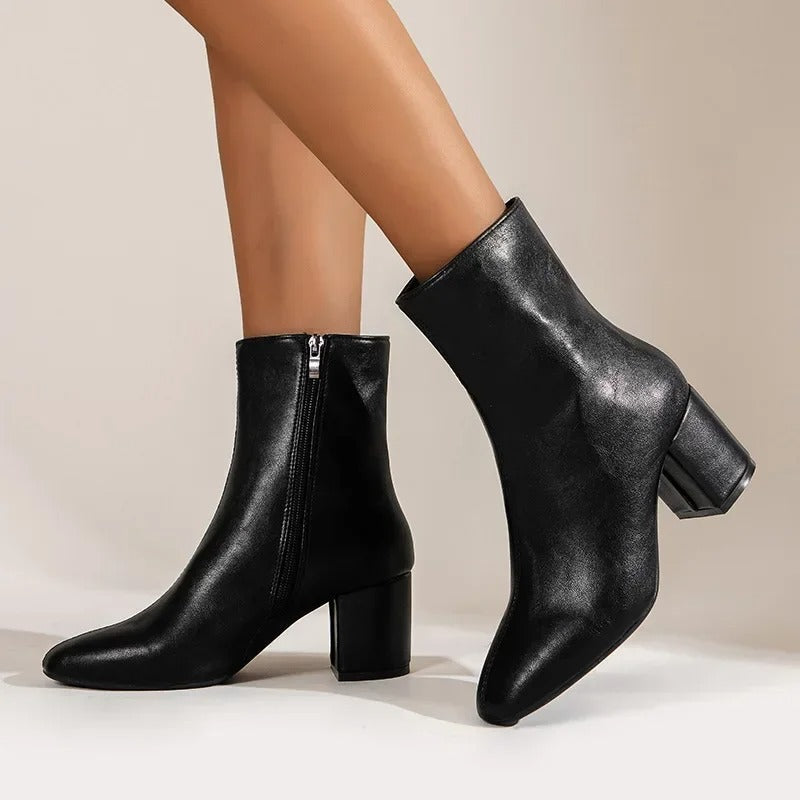 Classic women's pointed toe ankle boots with a modern block heel, offering timeless versatile fashion.