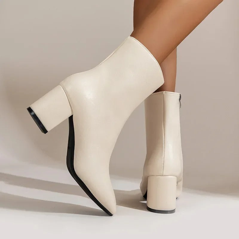 Side view of modern women's pointed toe ankle boots with a chic block heel, perfect for various occasions.
