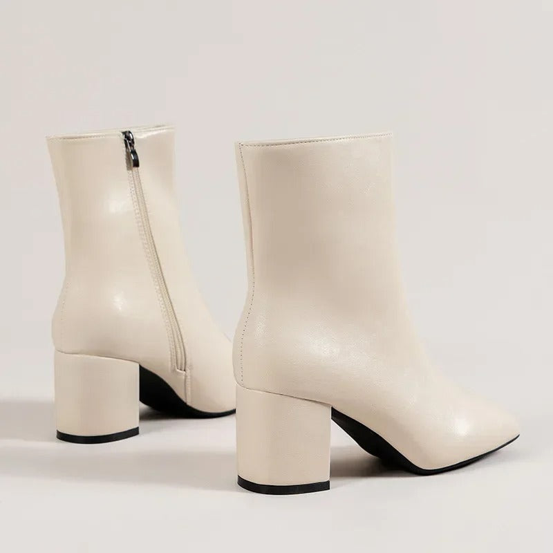 Chic black women's pointed toe ankle boots with a versatile block heel, a modern fashion statement.