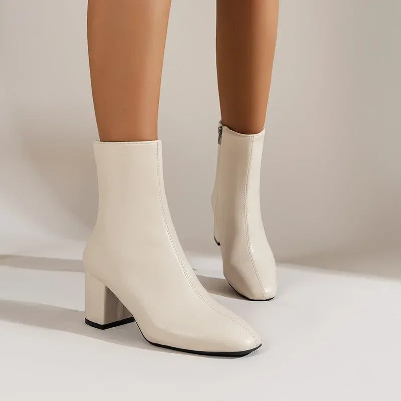 Comfortable women's pointed toe ankle boots with a stylish block heel, blending elegance and modernity.