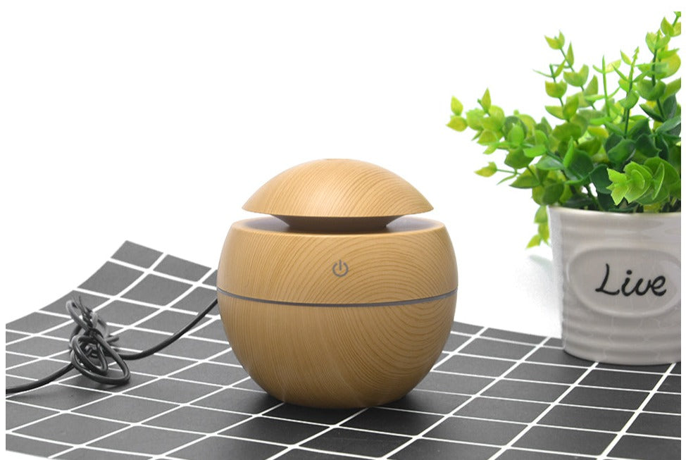Experience calm & serenity with this mini wood grain aromatherapy diffuser & favorite essential oils.