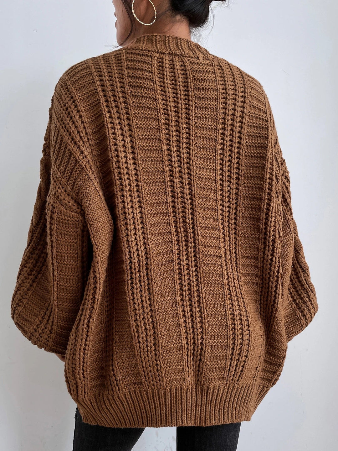 Stylish women's oversized cable knit cardigan in a relaxed fit, ideal for casual winter wear.