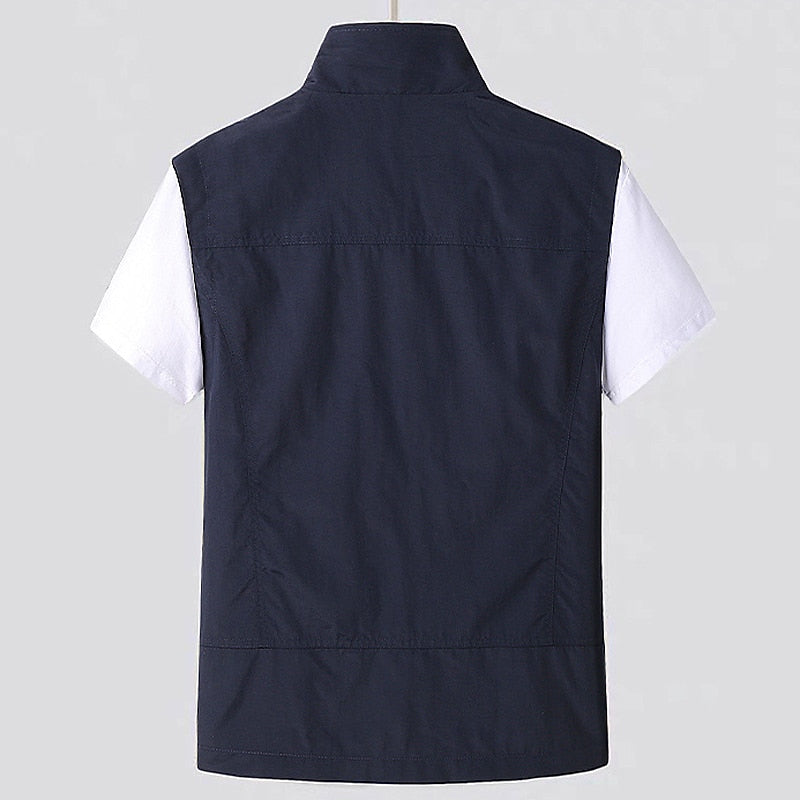 Men's lightweight travel vest featuring a water-repellent finish, full zip, and multiple utility pockets.
