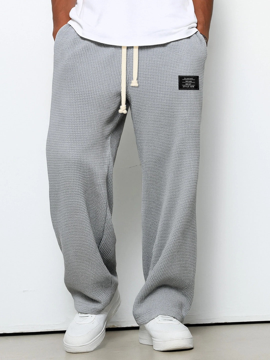 Comfortable men's loungewear trousers, featuring waffle knit, wide leg, and drawstring.