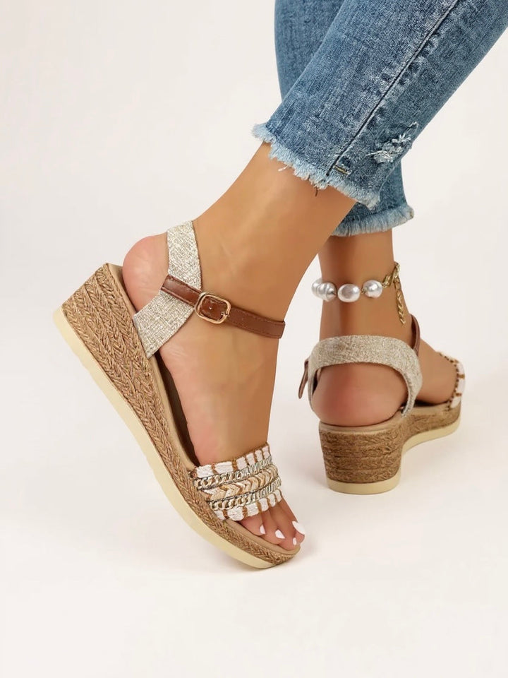 Stylish ladies braided wedge sandals featuring an open toe and comfortable heel, great for warm weather & versatile fashion.