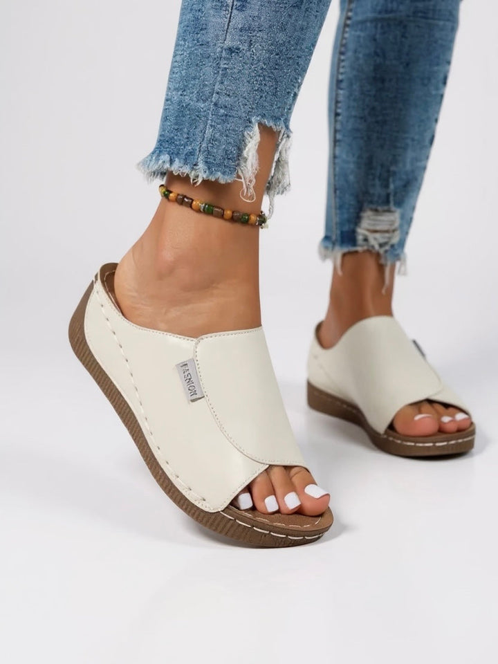 Women's minimalist platform slide sandals, perfect for effortless summer style.