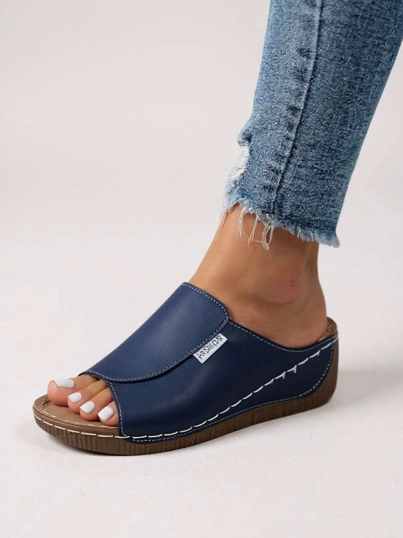 Women's minimalist platform slide sandals, a stylish pair for ultimate summer comfort and trend.