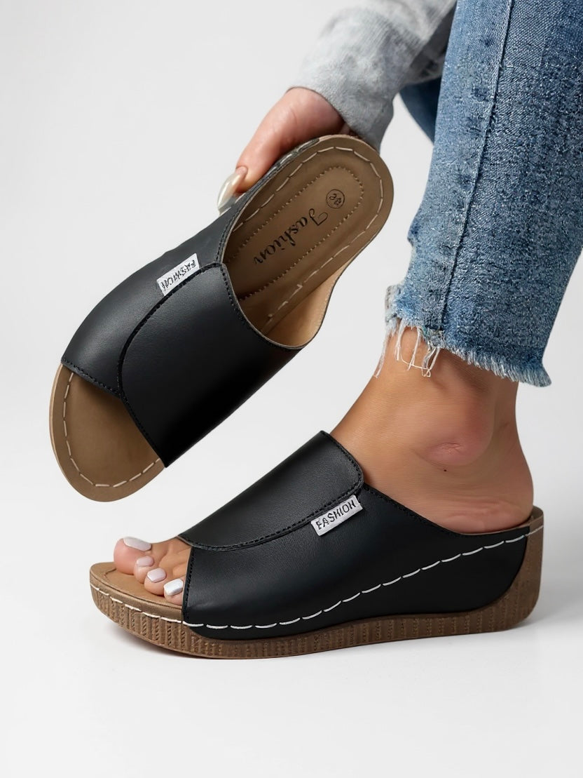 Chic women's minimalist slide sandals with wide strap, ideal for casual summer fashion.