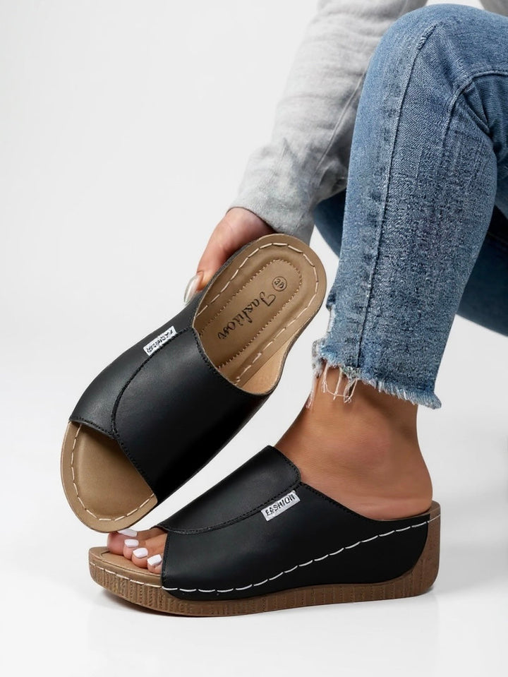 Durable women's platform slide sandals, offering a comfortable, trendy slip-on summer shoe.