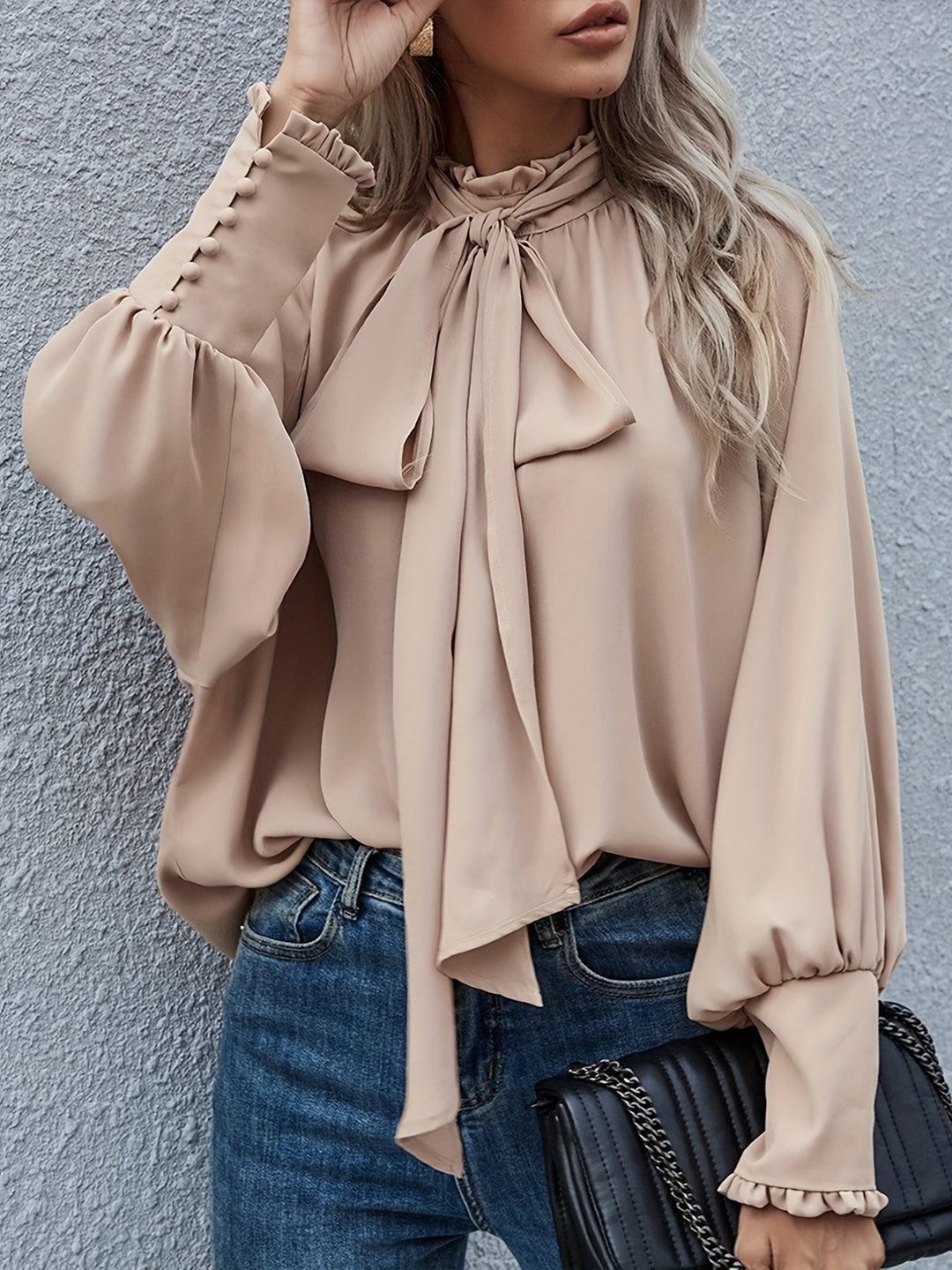 Classic black long sleeve tie-neck blouse for women. An elegant & versatile workwear or casual chic fashion piece.