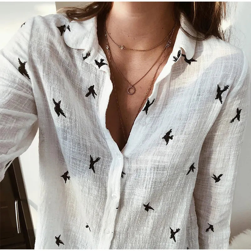 Stylish women's button-down blouse with colorful bird print. Long sleeve, relaxed fit.